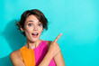 © deagreez - Photo of excited cheerful woman wear pink orange top showing finger empty space isolated teal color background