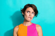 © deagreez - Photo of uncertain unsure woman wear pink orange top biting lip looking empty space isolated teal color background