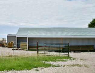 Canvas Print - Fence and Gate by a Metal Barn