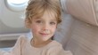 © chic designs - Smiling girl on a plane in the airport terminal happy ready to take a flight. Portrait of an excited cute Swedish little girl