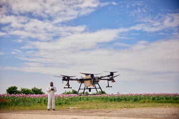 Male operator starting the agro drone with a controller.