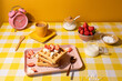 © ADDICTIVE STOCK - Bright and colorful breakfast setup with waffles and strawberries