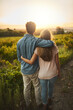 © Lyndon/peopleimages.com - Back, hug and couple in nature, outdoor and together with care, love and date for anniversary in park. Morning, partner and person with embrace, sunrise and peace in field and relax in Texas in farm