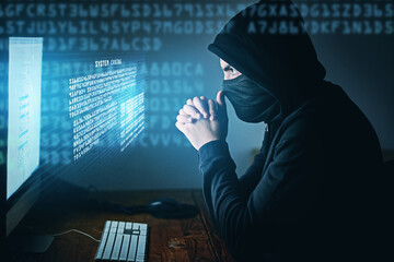 Fototapete - Cybercrime, hacker and thinking at computer for virus, overlay and futuristic at desk. Male criminal, hoodie and ready for coding, cyber attack and programming for malware with tech, scam and data