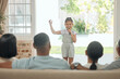 © peopleimages.com - Portrait, child and performance or singing with microphone in family home for creativity, talent and show. People, group and girl in lounge for karaoke, reunion and summer holiday in countryside