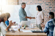 © peopleimages.com - Man, woman and shaking hands for welcome to startup with smile, support and introduction to team on office. Business people, leader and handshake with new employee with deal, agreement and applause