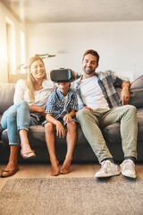 Wall Mural - Virtual reality, family and child relax on sofa with headset for futuristic, digital interaction or learning in home. Lens flare, metaverse and kid for simulation, curiosity or education video game