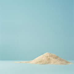 Wall Mural - pile of sand against a pastel blue background.Minimal creative summer vacation concept.Flat lay