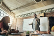 © peopleimages.com - Board, black man or speaker in presentation for questions, teaching or SWOT analysis in meeting. People, business workshop or leader talking in team training, coaching class or learning opportunity