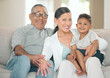 © peopleimages.com - Portrait, family and happy for love or relax in home living room with grandmother, grandpa and child. Grandparents, boy and smile as household for care, trust or bonding together in lounge on sofa