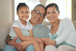 © peopleimages.com - Family, portrait and happy for love or relax in home living room with grandmother, grandpa and child. Grandparents, kid and smile as household for trust, care or bond together in house lounge on sofa