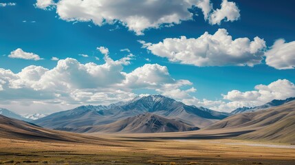 Wall Mural - mountain landscape below a clear azure sky with fluffy white clouds