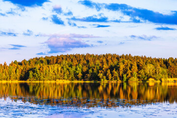 Wall Mural - Breathtaking sunset scenery over the lake, mirroring the colorful forest trees. Sweden.