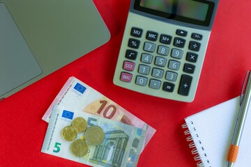 calculator and money, red background