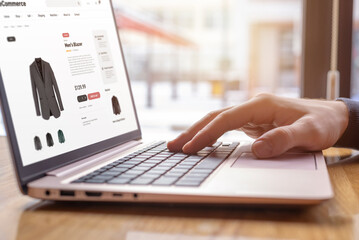 Poster - Close-up of hands typing on laptop, shopping online for men's blazer. Modern digital shopping experience for fashion enthusiasts
