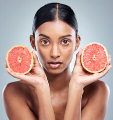 Canvas Print - Grapefruit, skincare and woman with portrait in studio for facial treatment, natural or glowing skin on white background. Wellness, fruit and model for vitamin C, dermatology or organic cosmetics