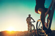 © peopleimages.com - Sunrise, people and friends on bicycle with adventure, race and exercise trail in nature together. Cycling, fitness and team with mountain bike in morning for outdoor workout, blue sky and grass path