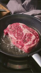 Sticker - A chef cooks a beef steak on a pan in the kitchen, food close-up. Process of making delicious steak.