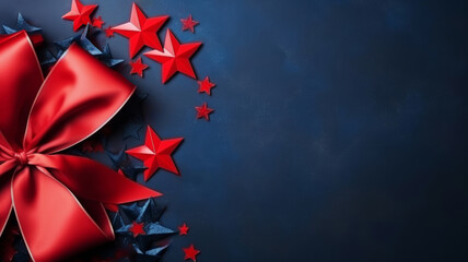 Red Bow with Long Ribbon and Scattered Blue Stars on Dark Blue Background with copy space