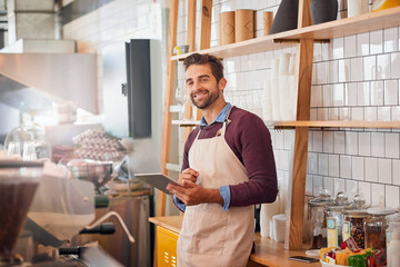 Fototapete - Coffee shop, restaurant and man on tablet for online menu, checking stock and inventory. Small business, cafeteria and happy owner or waiter on digital tech for social media, networking and website