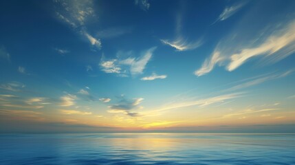 A beautiful blue sky with a few clouds and a calm ocean