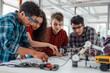 © Fox - A team of diverse students collaborating on a robotics project in a modern lab, showcasing teamwork, innovation, and creativity in STEM education. They are working together in a hightech environment