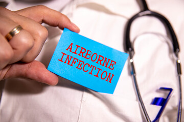 Wall Mural - The words AIRBORNE INFECTION on a wooden cubes with a stethoscope