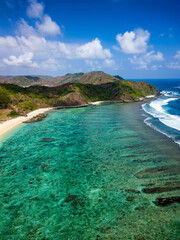 Wall Mural - Aerial view of a sandy tropical beach and coral reef surrounded by hills (Tampah)
