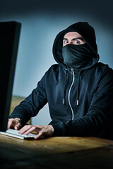 Fototapete - Computer, hacker and portrait of man at night for cyber attack, fraud and digital scam at home. Cybersecurity, crime and male person with technology by table for privacy risk, coding and ransomware