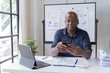 © Tj - Creative african businessman senior american worker using computer device in office,chat online, thinking business solution planning difficult decision pondering strategy come up with idea.