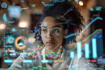 Poster - A woman wearing glasses is looking at a computer screen with a lot of graphs