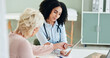 © peopleimages.com - Hospital, tablet and doctor with patient for consulting, medical service and help in clinic. Healthcare, telehealth and woman and mature person on digital tech for diagnosis, results and insurance