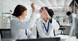 © peopleimages.com - Women, high five and laptop in lab for science, notification or celebration for research project. People, scientist and lab partner by computer for cheers, excited or results for funding application
