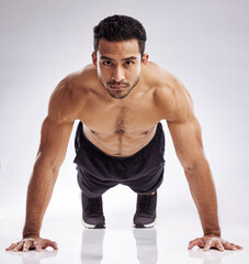 Poster - Portrait, push up and man in studio for fitness, body care and wellness for health and muscles. Male person, athlete or bodybuilder and training for strength, exercise and workout by white background