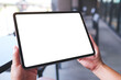 © Farknot Architect - Mockup image of a woman holding digital tablet with blank white desktop screen in cafe