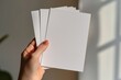 © dendyh7 - Blank paper mockup on hand created with generative AI