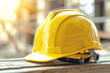 © CozyDigital - Safety on construction site. Yellow construction helmet lies on wooden table.