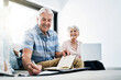 © ReadyAtTheEase/peopleimages.com - Laptop, writing and senior couple in home planning for retirement fund, savings and asset management. Online, computer and elderly man and woman with budget notes for bills, mortgage and debt payment