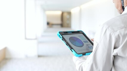 Poster - Engineer checking a building while looking at a tablet