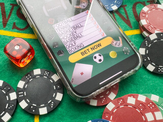 Wall Mural - online casino smartphone with poker chips device over green table