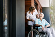 © ReadyAtTheEase/peopleimages.com - Nurse, talking and senior woman on wheelchair for support or rehabilitation of medical healthcare patient. Happy caregiver, retirement or person with disability at home for recovery, wellness or help