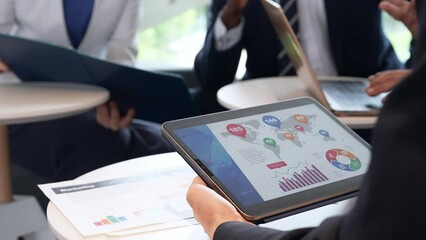 Aufkleber - A group of business people having a meeting while looking at a tablet