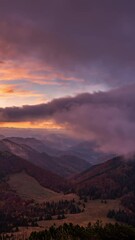 Wall Mural - clouds moving fast in autumn mountains before sunrise, vertical video