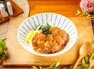 Japanese Curry Pork Chop Rice served in dish isolated on wooden table side view of taiwan food