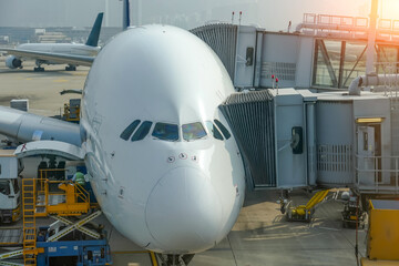 Wall Mural - Huge airplane jet connected to terminal via jet bridge