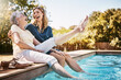 © peopleimages.com - Mother, daughter and happiness by swimming pool for wellness, hug or relax with lens flare in garden. Senior mom, woman and outdoor with smile for bonding, family with embrace or love and foot in air