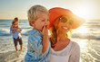 © ReadyAtTheEase/peopleimages.com - Happy mother, family and beach with hug in sunset for outdoor holiday, weekend or bonding in nature. Mom, child and little boy with smile for embrace, love or care in sunshine by ocean coast or sea