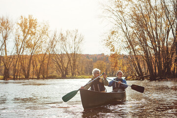 Lake, senior couple and kayaking in nature with canoe for explore, adventure or retirement activity. Outdoor, river and elderly woman with man on boat for rowing, holiday or weekend break in Sydney