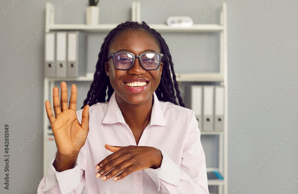 Happy smiling african american woman waving hand saying hello having ...