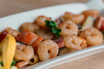 Shrimp salad with lemon on a white plate